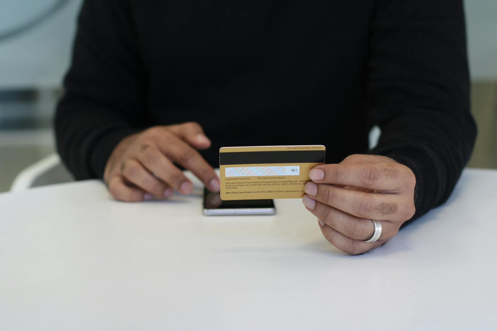 close up shot of a person holding a bank card