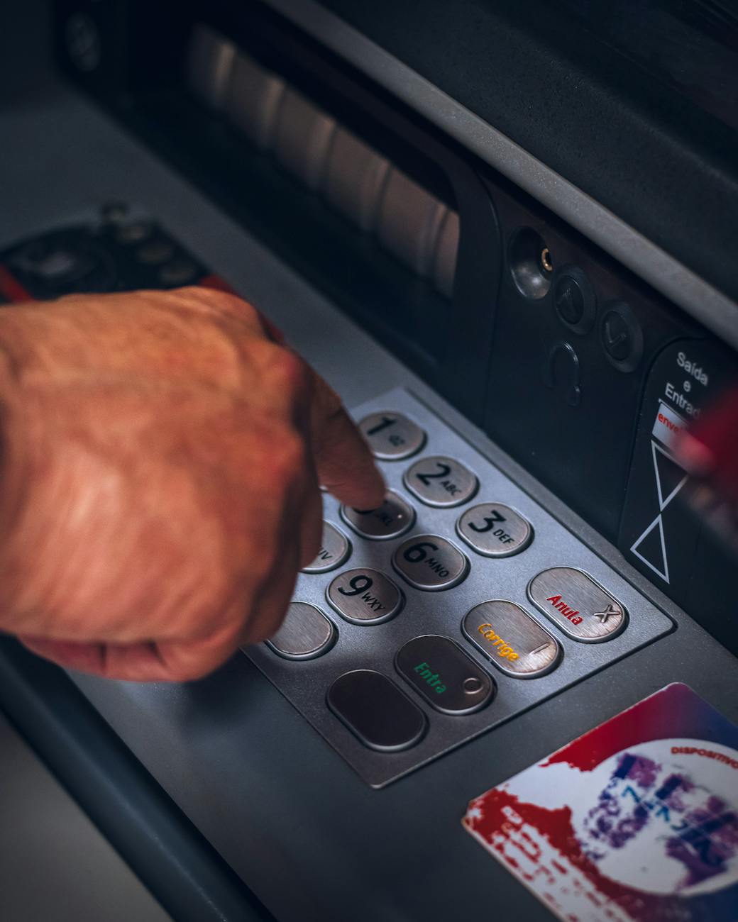 person pressing keys of an atm