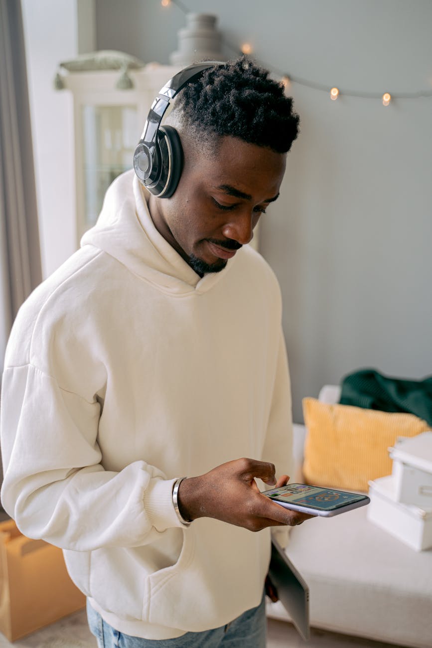 man in white sweatshirt with headphones