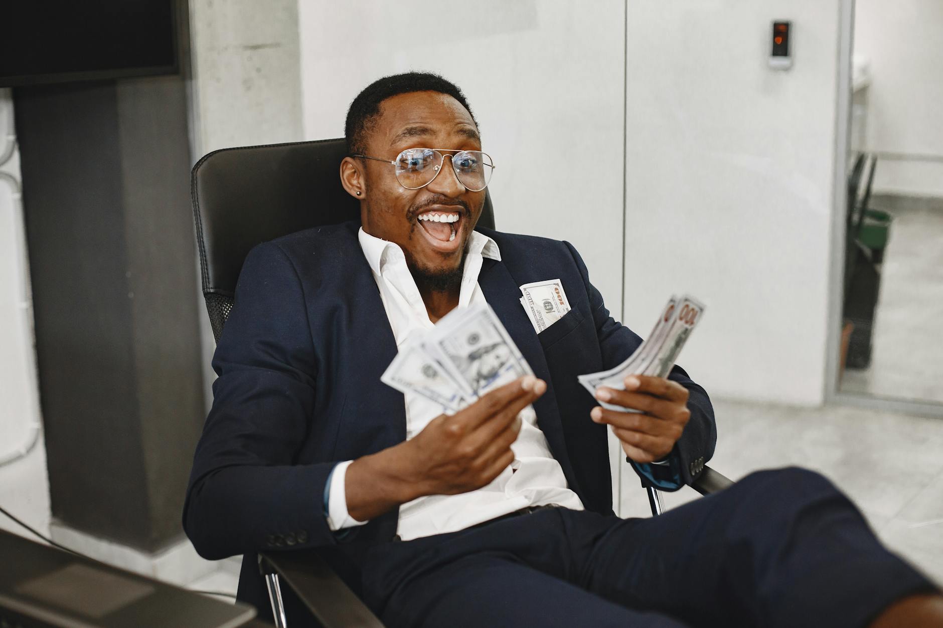 happy businessman holding paper money