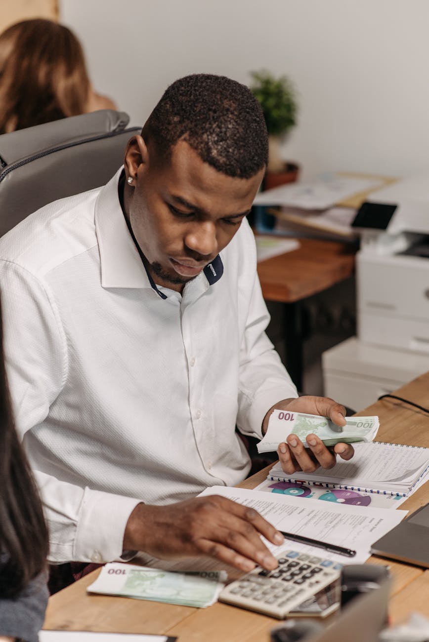 man in white long sleeves working in the office