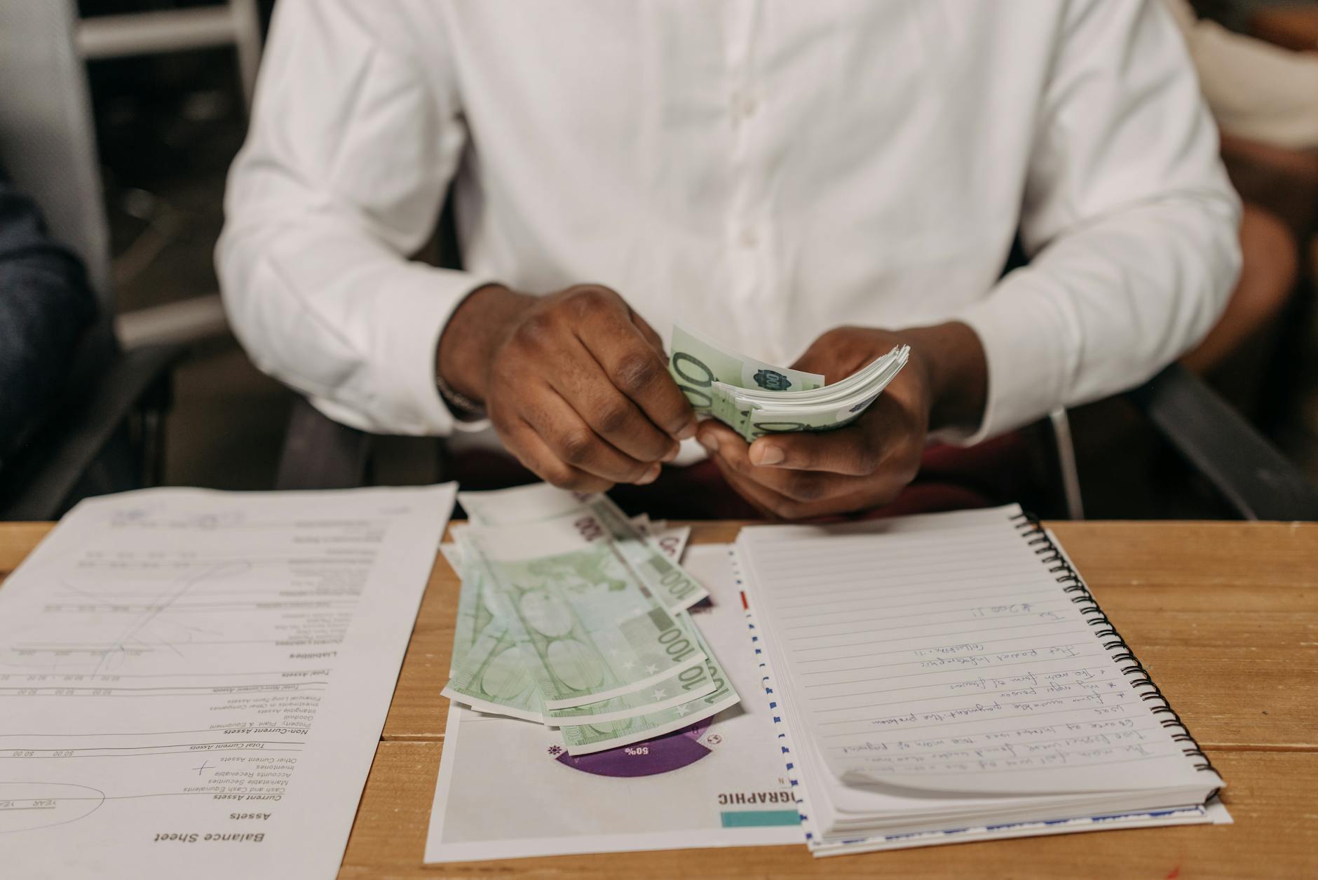 man counting money in office